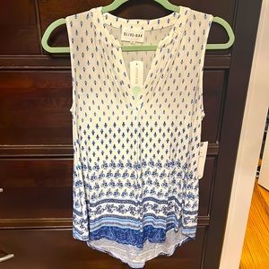 Sleeveless tunic. High low design. New with tags. Size S